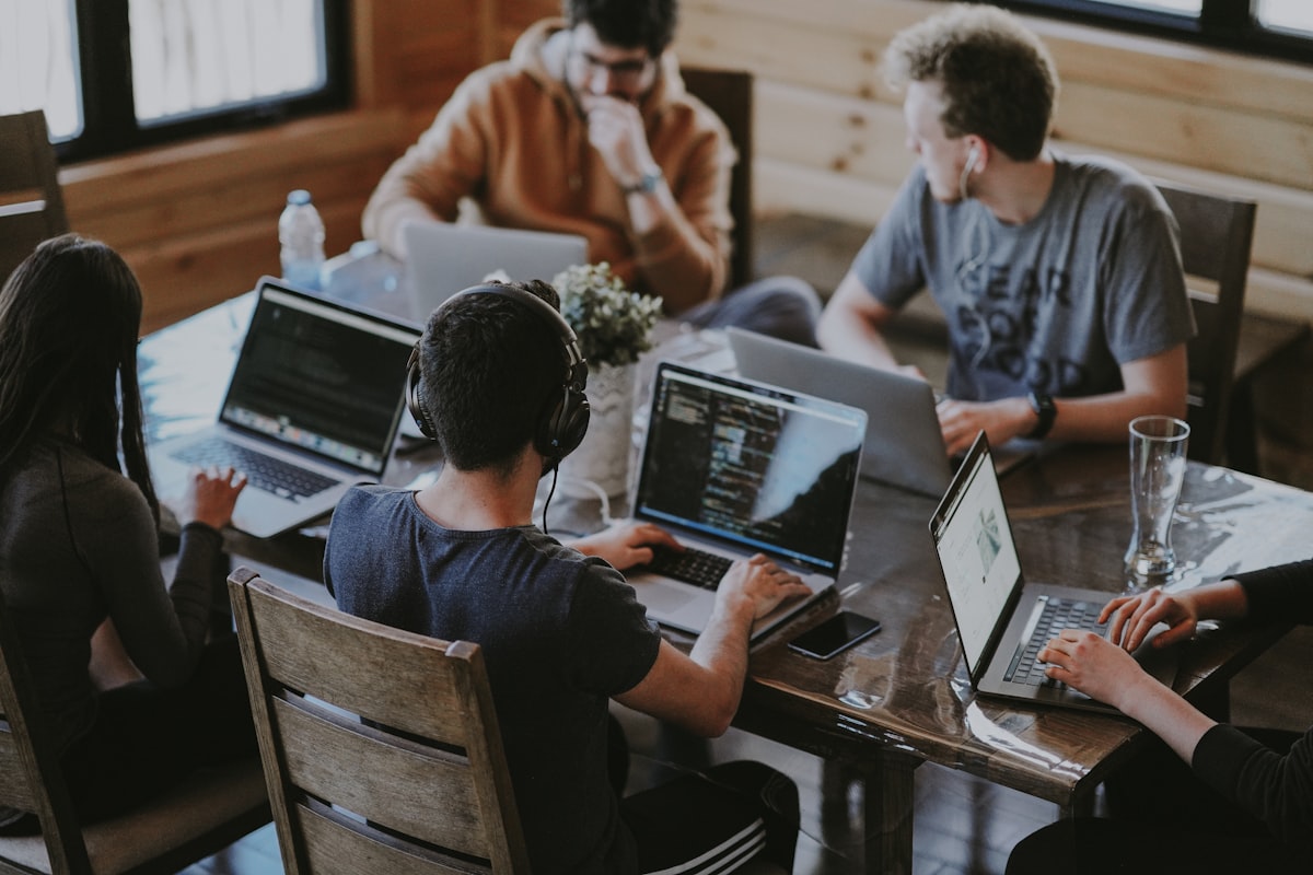 A team collaborating around a screen